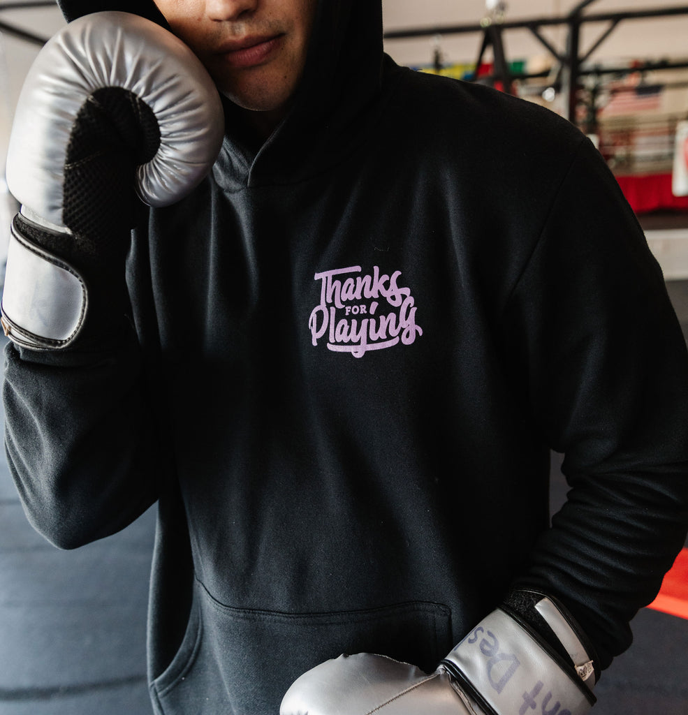 The front side of the Levels Upon levels Fight hoodie worn at a boxing gym.