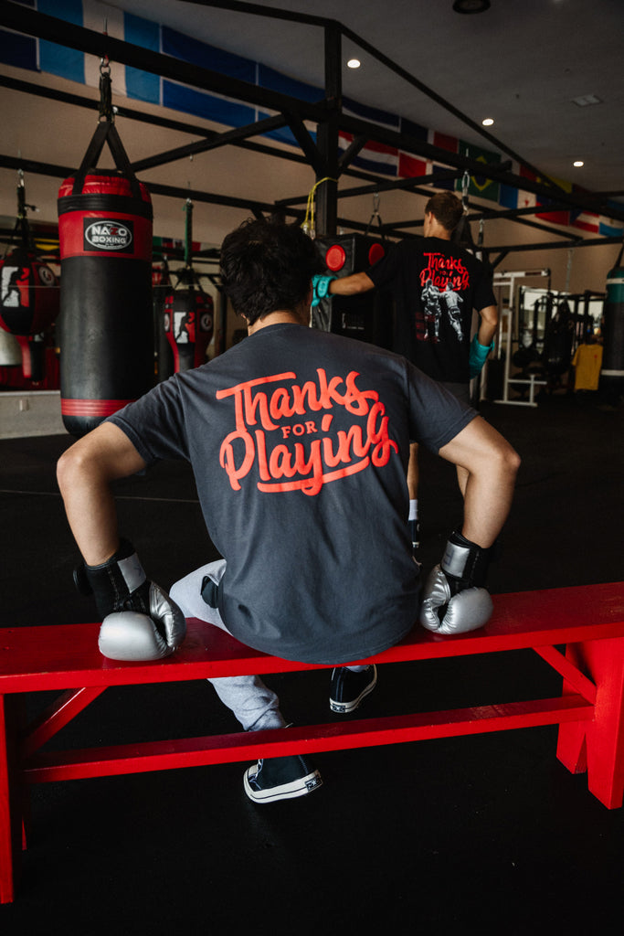 The back side of the red logo tee worn at a gym.