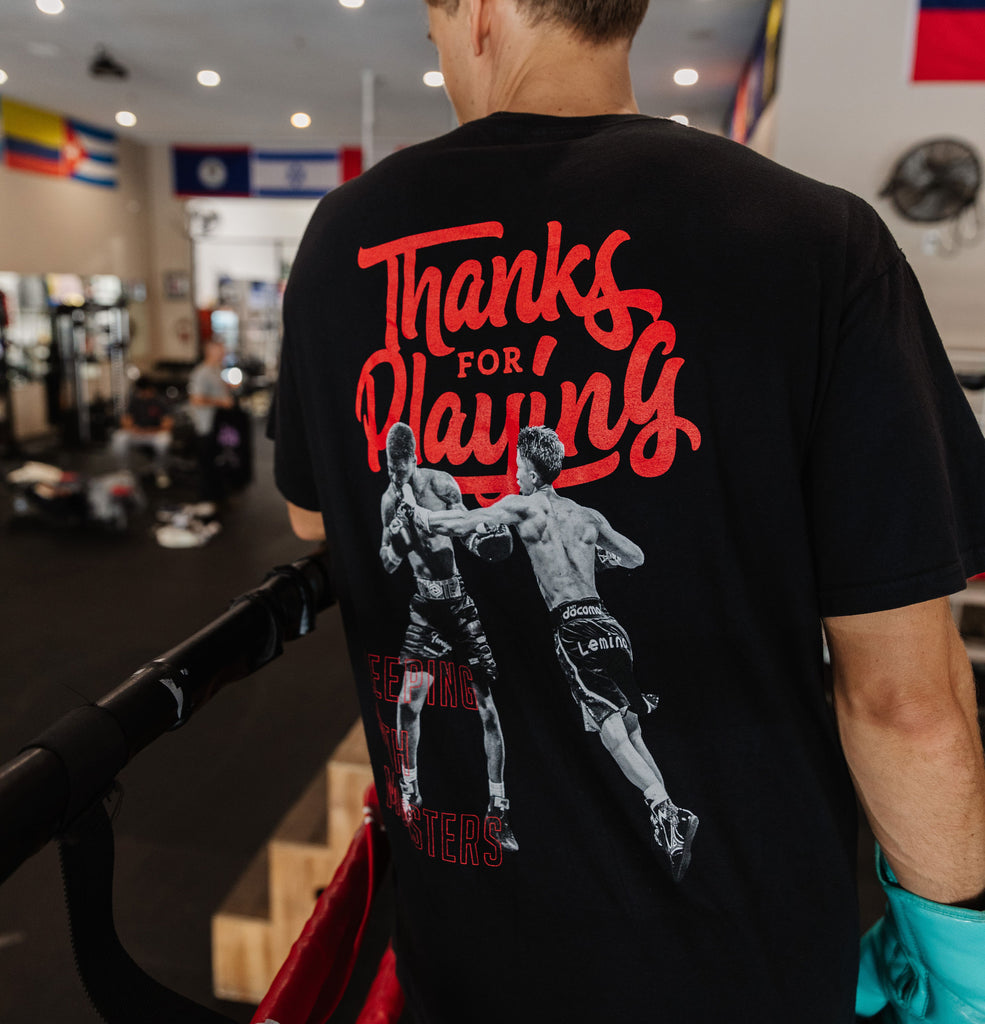 The back side of the black Sleeping with Monsters Fight shirt worn at a boxing gym.