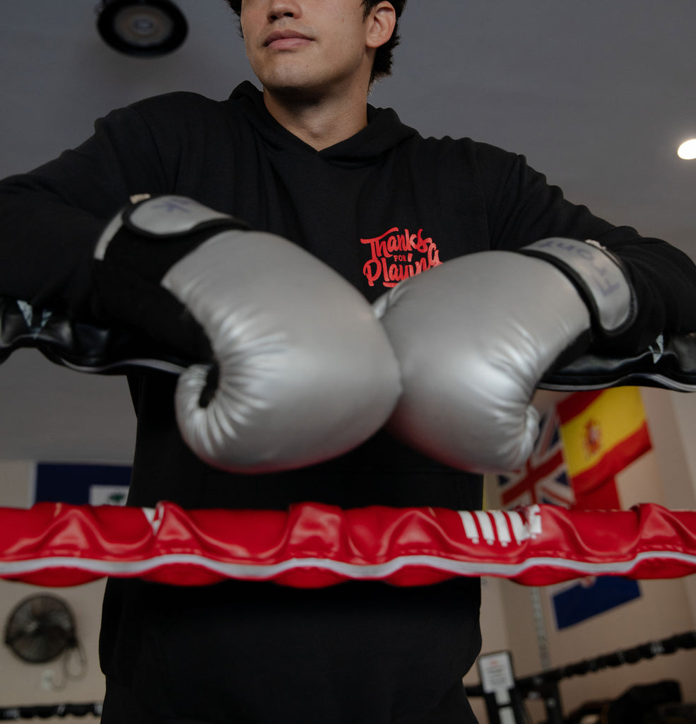 The front side of the Sleeping with Monsters Fight hoodie worn at a boxing gym.